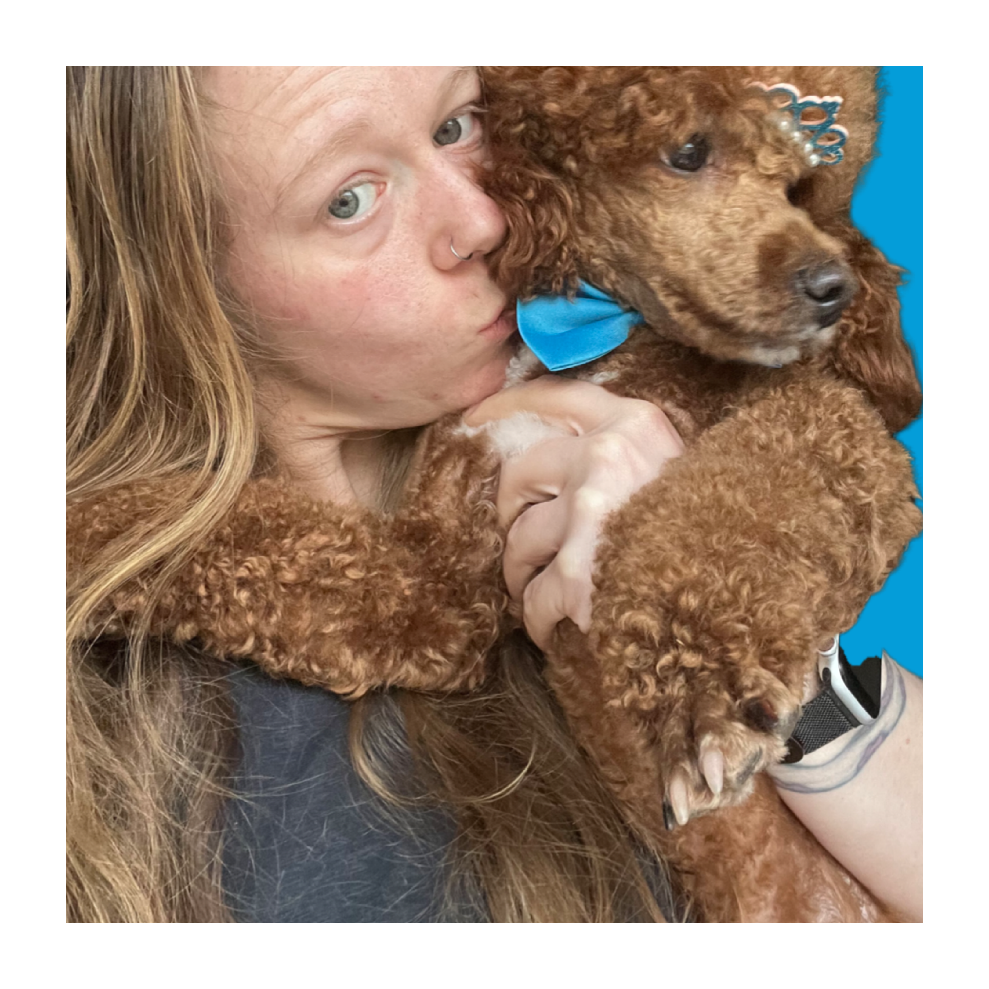 Olivia kissing a red poodle at Paws to Perfection