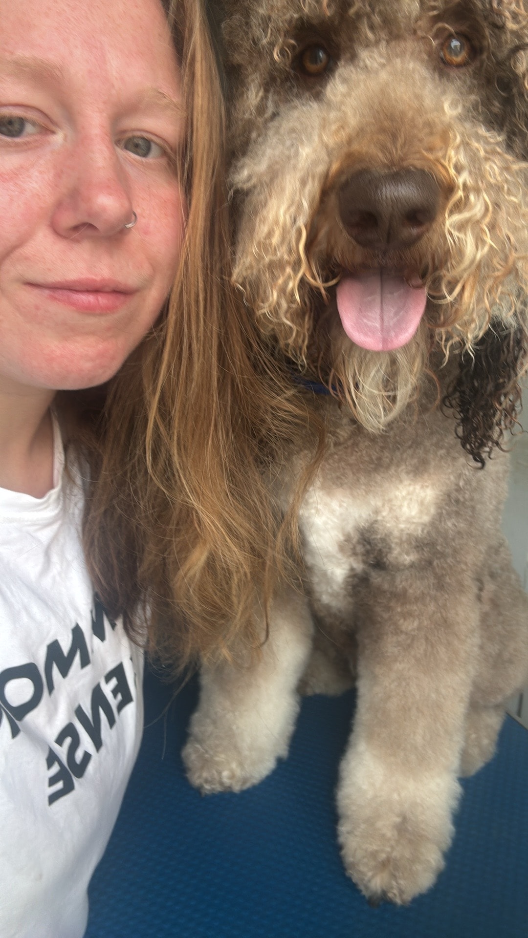 Olivia with a dog at Paws to Perfection